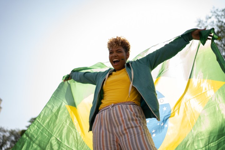 Young woman with a brazilian flag outdoors