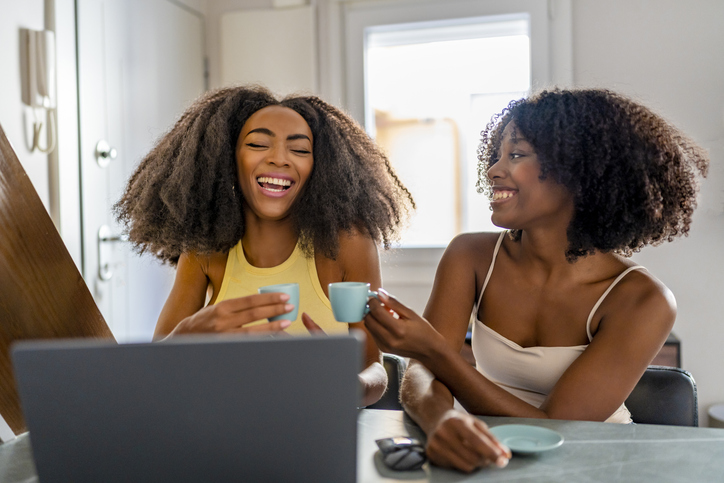 Cheerful freelancers having coffee and working at home