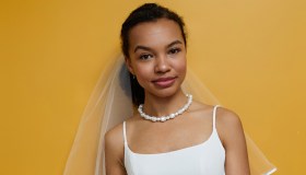 Vertical portrait of elegant black young woman wearing wedding dress