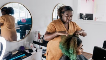 Black Hairdresser Preparing Client's Hair Before Cutting And Styling