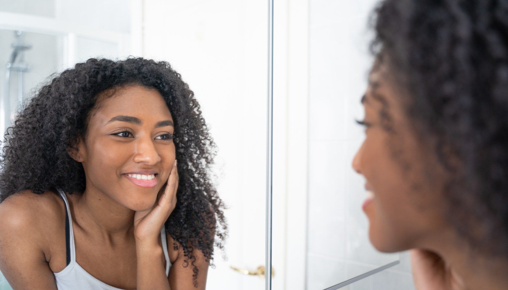 A Black woman admiring her beauty