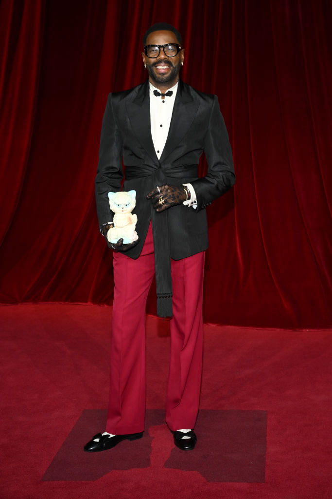 Colman Domingo carries a cat.