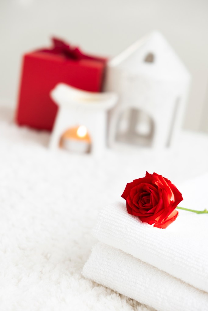 White towels with red rose and candle