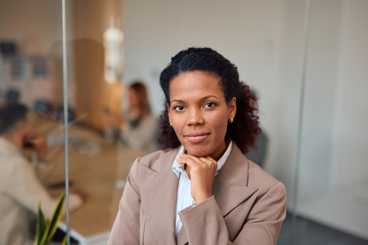 black women jobs, unemployment

Confident businesswoman posing in modern office with team working in background