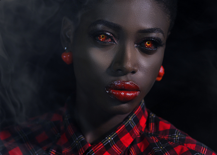 Close-Up Portrait Of Young Woman Against Black Background