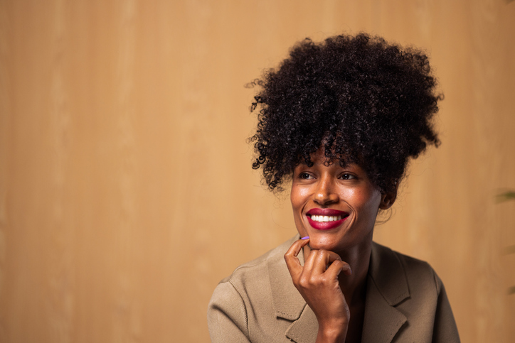 African american businesswoman smiling, looking away with ideas