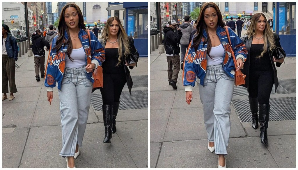 Two young women walking together on a city street, one wearing a blue and orange patterned jacket and the other in a black outfit.