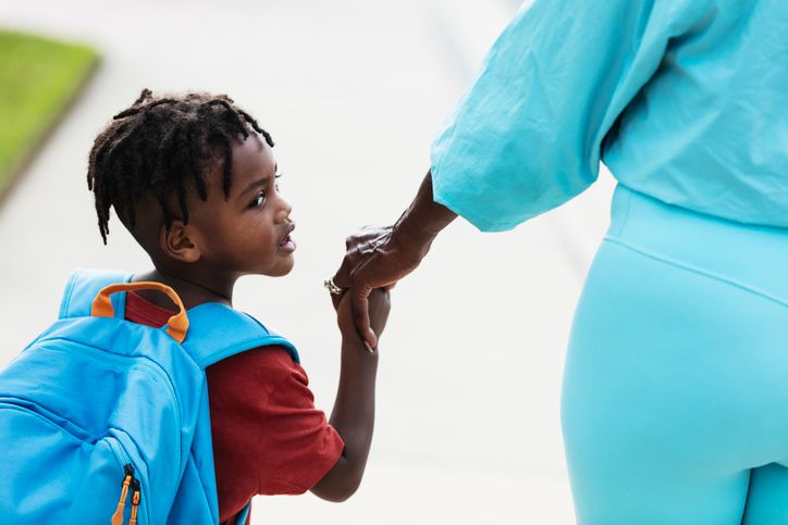 Little boy going to preschool with grandmother