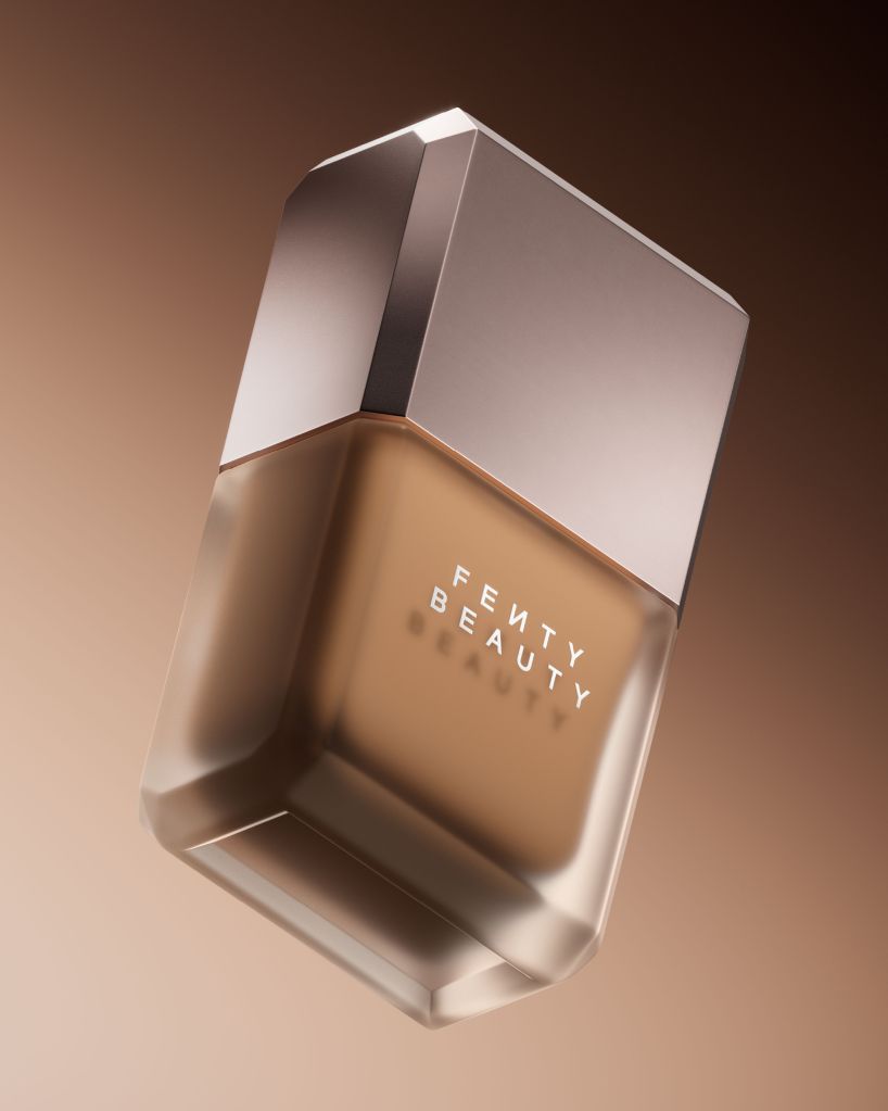 A silver-colored perfume bottle with the text "FENTY BEAUTY" printed on the front.